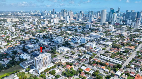 Panoramic aerial view of a city with numerous buildings and skyscrapers.