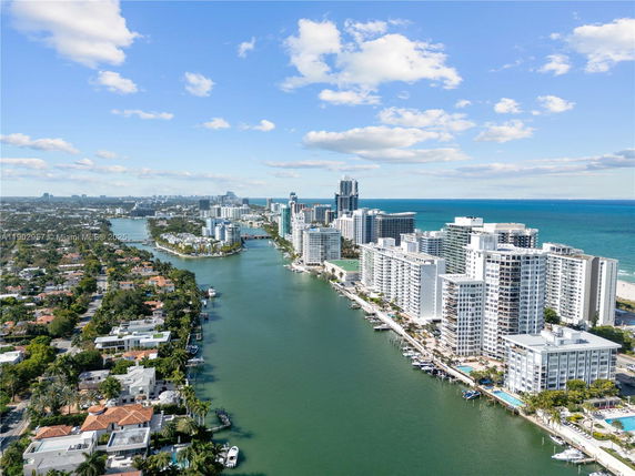 Panoramic view of waterfront high-rise buildings and ocean.