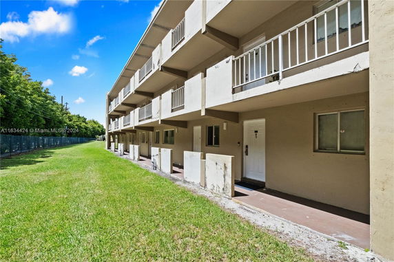 Side view of a multi-story building with balconies.