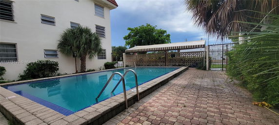 Outdoor swimming pool area next to a building.