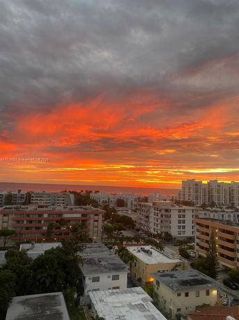 Panoramic view of the city with a vibrant sunset sky.
