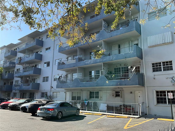 Front view of a multi-story residential building with balconies.