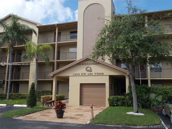 Front view of a multi-story residential building with balconies.