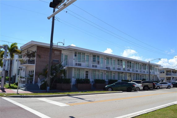 Front view of a two-story apartment building with balconies.