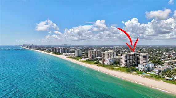 Wide-angle view of beachfront buildings along a coastline.
