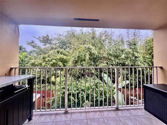 Balcony view overlooking lush greenery.