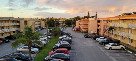 Outdoor parking area between apartment buildings.