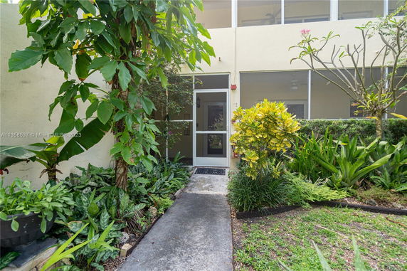 Entrance of a building with a garden path and greenery