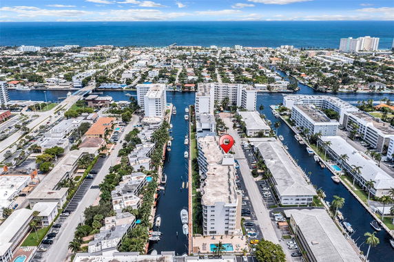 Aerial view of coastal cityscape with canals and high-rise buildings.