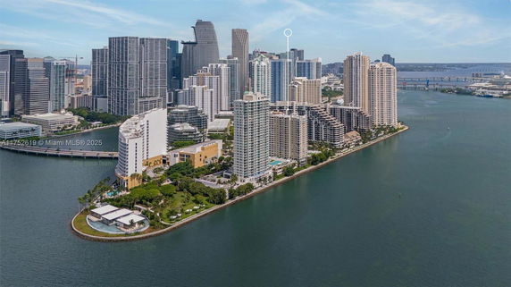 Panoramic view of a cityscape with high-rise buildings on a waterfront.