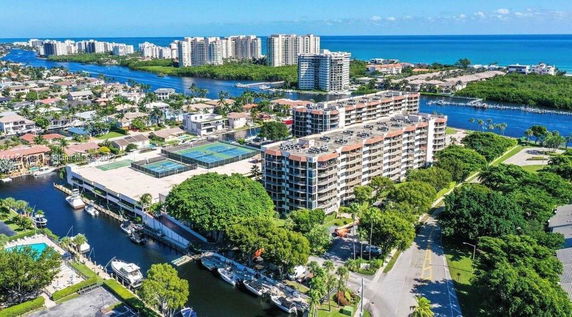 Aerial view of a residential area with apartment buildings near a waterway.