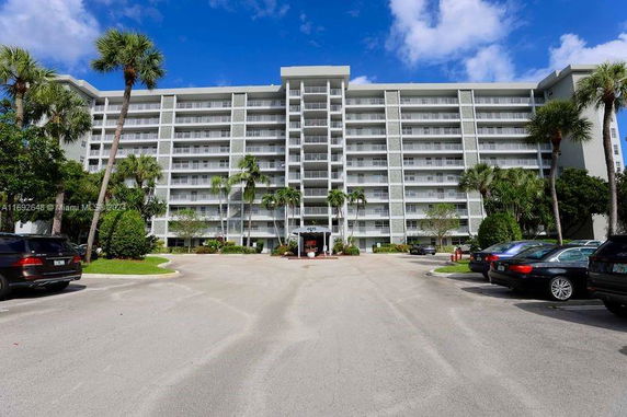 Front view of a multi-story apartment building with balconies.