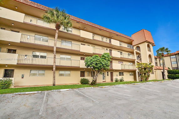 Front view of a multi-story apartment building with balconies