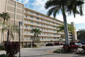 Front view of a multi-story apartment building with balconies.