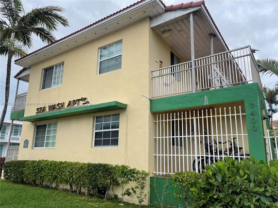 Front view of a two-story apartment building with a balcony.