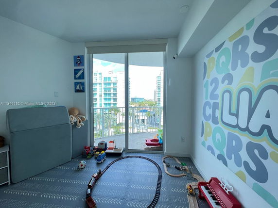 Children's play area with toys and a colorful alphabet wall design.