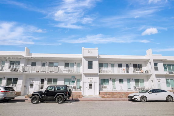 Front view of a modern two-story apartment building with balconies.
