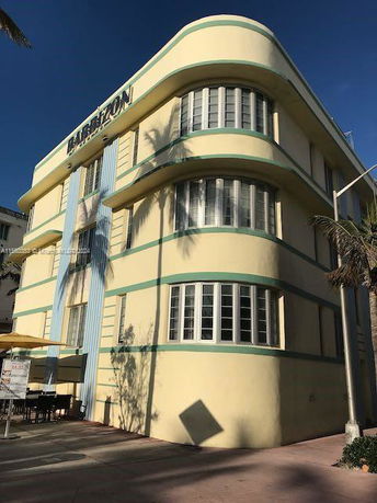 Front view of a three-story Art Deco style building with rounded corners and horizontal lines.