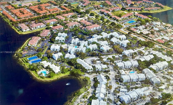 Aerial view of a residential area with multiple buildings and surrounding landscape.