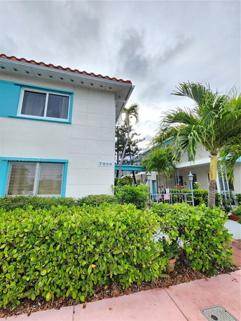 Front view of a two-story building with blue accents and a tile roof.