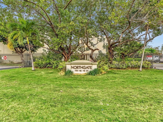 Front view of a building's gated entrance with a sign reading 'Northgate 1701 NE 115 St'.