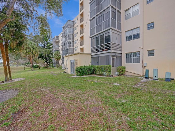 View of multi-story residential building with balconies and screened porches.