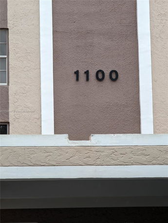 Front view of a building with the number 1100 displayed.