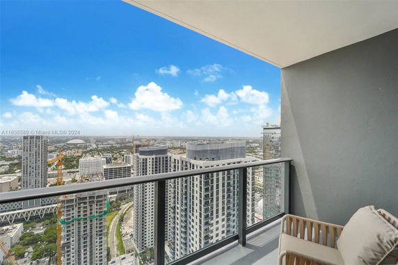 Panoramic view of a cityscape from a high-rise balcony.
