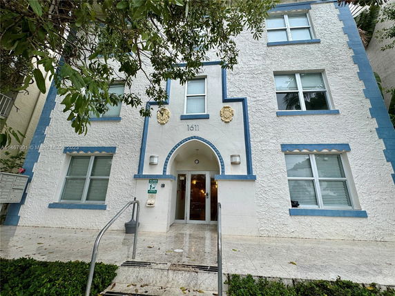 Front view of a multi-story building with blue accents.