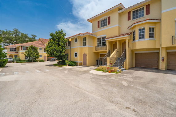 Front view of a multi-story residential building with garages.