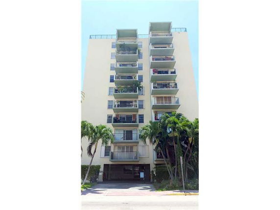 Front view of a multi-story apartment building with balconies