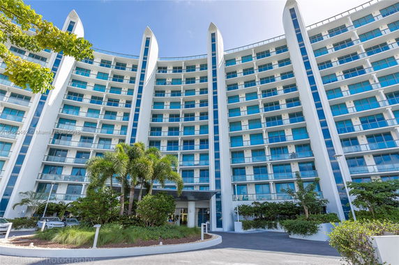Front view of a multi-story modern building with curved design.
