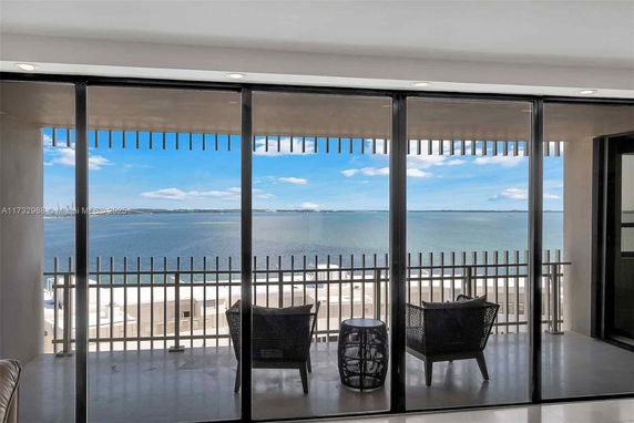 View from a balcony overlooking a body of water with a cloudy sky.