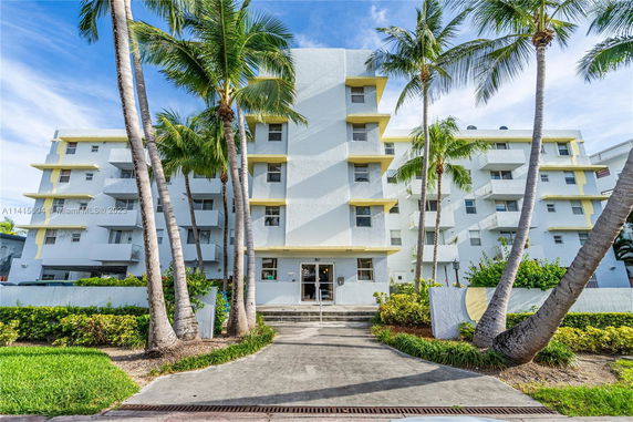 Front view of a multi-story residential building with balconies.