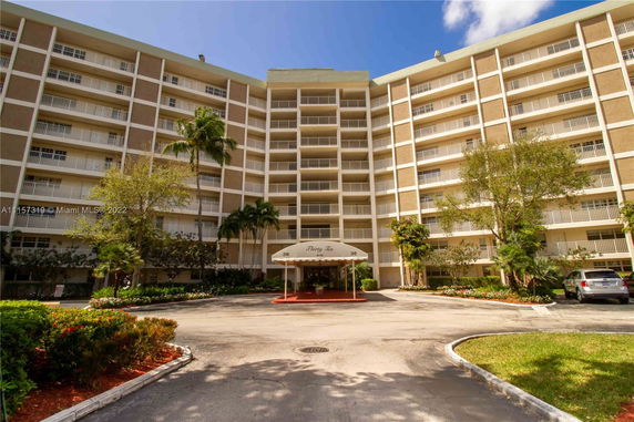 Front view of a multi-story residential building with balconies.