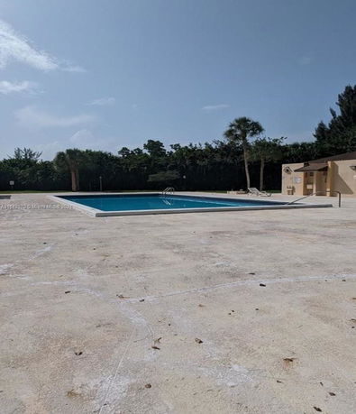 Outdoor swimming pool with surrounding paved area.