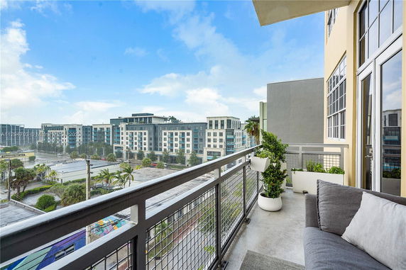 View from a balcony showcasing modern apartment buildings in an urban setting.