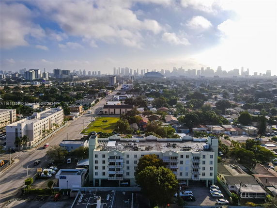 Aerial view of a cityscape with residential and commercial buildings.