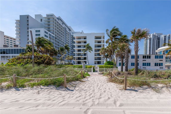 Front view of a multi-story beachfront building complex.