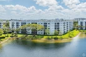 Wide view of a multi-story apartment complex next to a body of water.
