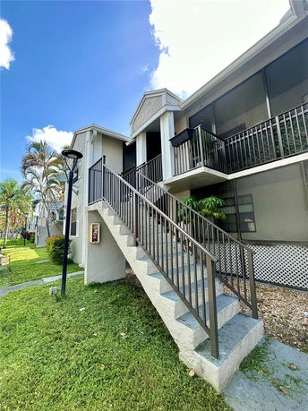 Front view of a multi-story building with exterior staircase.