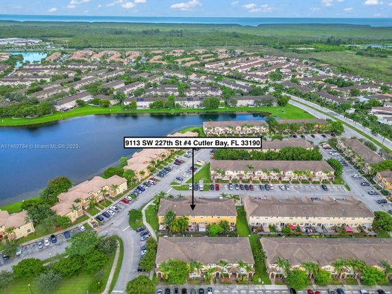 Aerial view of a residential area with buildings, roads, and a water body in Cutler Bay.