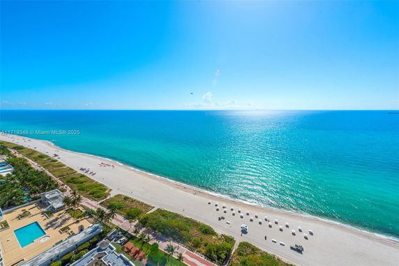 Panoramic view of a beach and ocean from a high angle.