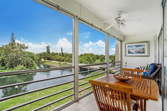 View from a balcony overlooking a waterway and greenery.