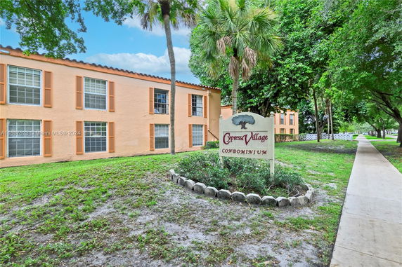 Front view of a condominium building with large windows.
