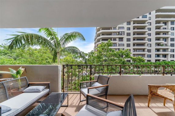 View from a balcony showing residential buildings and greenery.