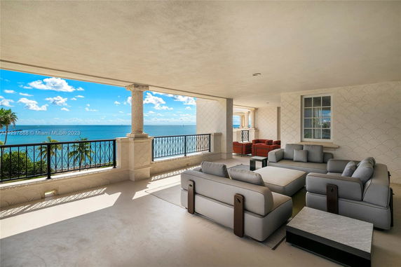 Covered terrace with seating area offering a panoramic ocean view.