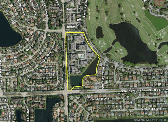 Aerial view highlighting a residential area with roads and water bodies.