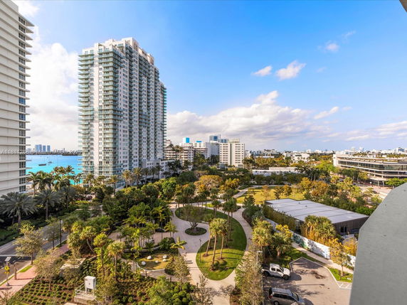 Panoramic view of a cityscape with high-rise buildings and greenery.