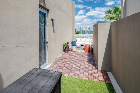 Rooftop area with wooden deck and seating area.
